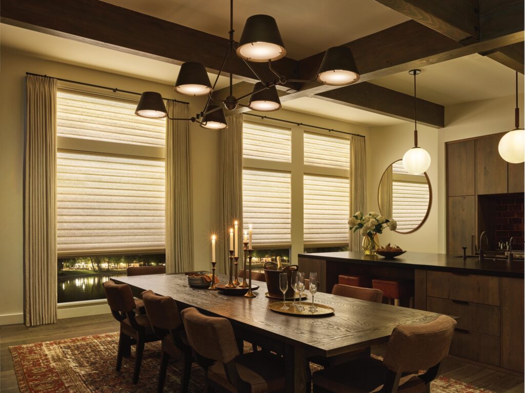 Cozy lighting from the Aura Illuminated Shades is a window treatment trends 2025