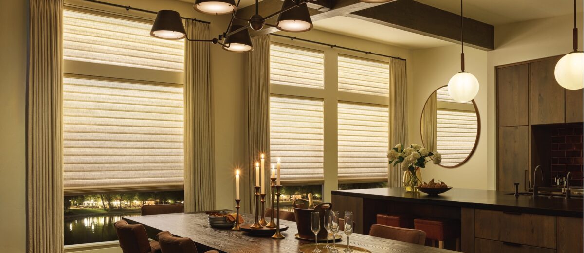 Cozy lighting from the Aura Illuminated Shades is a window treatment trends 2025